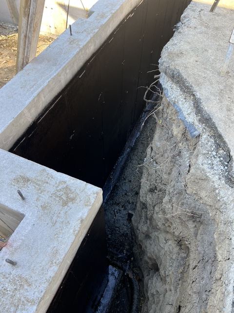 Black damp proofing on the outside of a foundation wall