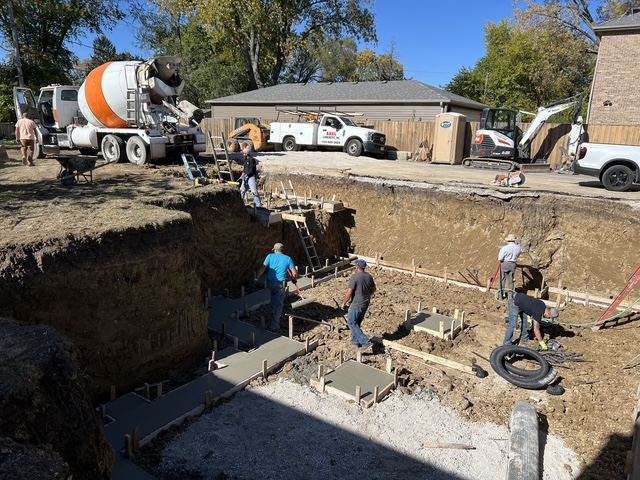 Crew pouring footings and pads straight off a concrete truck
