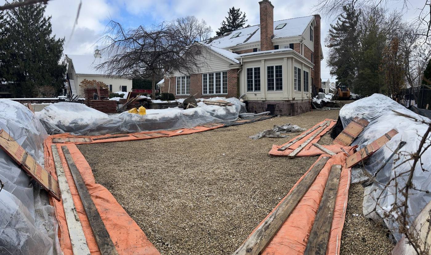 Footings covered in blankets with a leveled gravel base inside