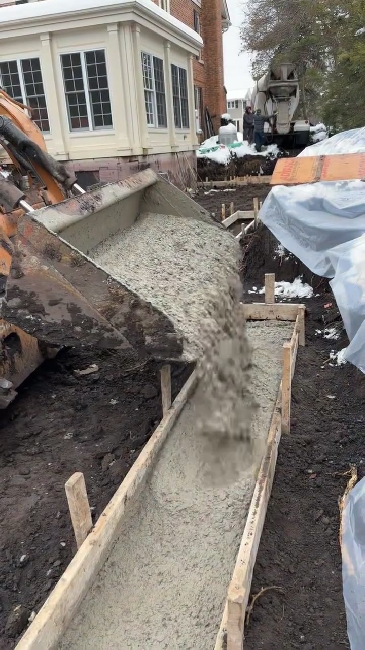 Concrete pour in a tight side yard next to a house